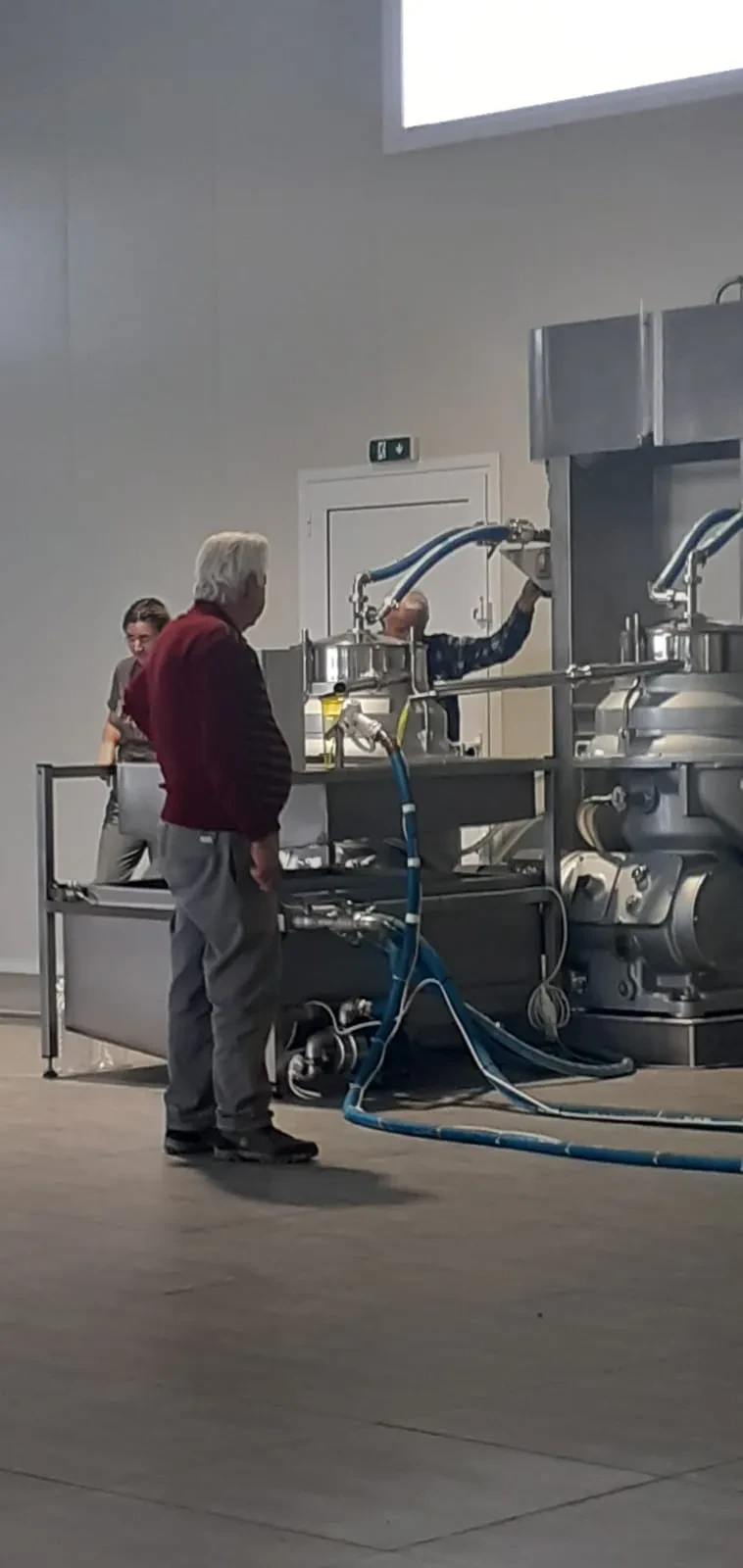Ευάγγελος (Angelo) at the mill, watching over the pressing
