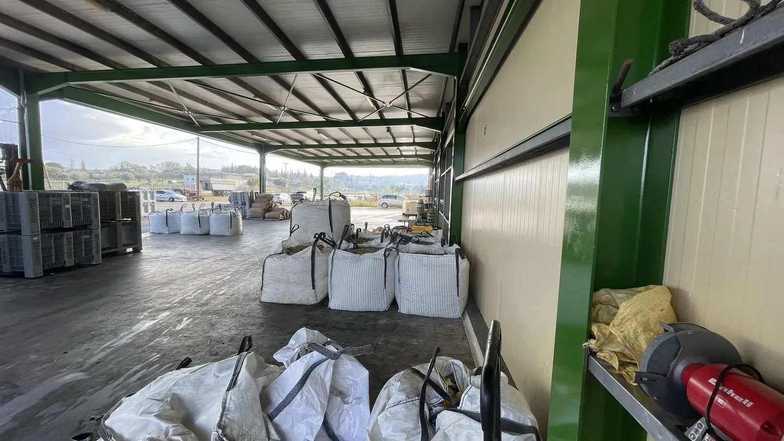 Crates of olives waiting under cover at the mill