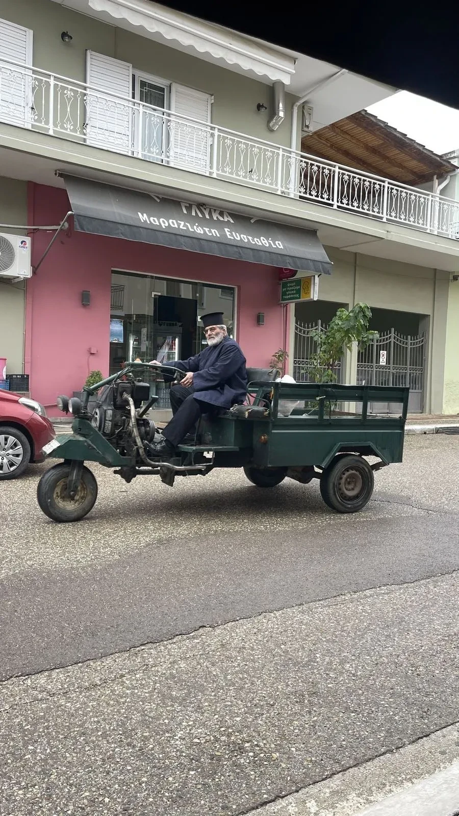 The village priest riding his tractor through Chavari